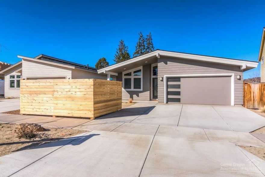 Hard to find like new home in NE Bend with No HOA's! Built in 2018, turn key single level living with vaulted ceilings, large master with 2 additional bedrooms and separate office. This home lives large and has been well maintained as it was a 2nd home. Two private outdoor spaces bring the outside in. Mountain and Pilot Butte views.