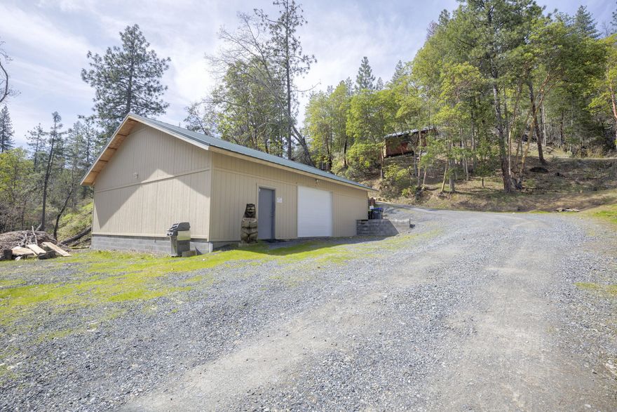 Breathtaking views from this quiet get-away! 2 bed 1 bath custom octagon home. One bedroom downstairs and one upstairs with a total of living space of 1052 SF. Tile floors, spiral staircase, upgraded kitchen and bathroom with dual shower heads! Fridge, washer and dryer included. Multiple outbuildings including 2 sheds with lofts with ADU potential and a knock your socks off permitted 36x40 shop built in 2022.  The shop is totally insulated on concrete slab with two more rooms inside. Two more storage sheds and an 1800 sf top of the line greenhouse to grow food for your family.  Property backs up to 5,000 acres BLM. The Seller may carry with a substantial down payment.  Come see to believe! More photos coming soon!!