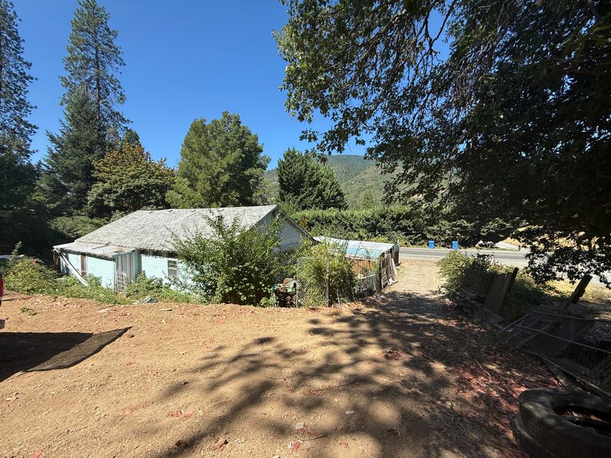 PRICED TO SELL! Motivated Seller!!
Bring your vision and your tools! This 2-bedroom, 2-bath home sits on nearly 1.5 acres just minutes from Rogue River and the I-5. The property offers excellent potential with a private well, septic system, and power to the home. CASH ONLY due to the condition and extensive clean-up needed. Property is priced accordingly. Value is in the land. Sold in as-is condition. Buyer and buyer's agent to do their own due diligence in regard to the use and condition of the home and property. Manufactured home behind the main house does not appear safe to enter; agents and buyers enter at your own risk.