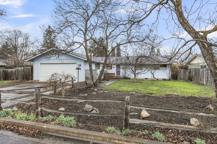 Charming 3 bedroom 2 bath single level home in desirable Quiet Village neighborhood. Located near Helman Elementary school, the dog park, and Bear Creek Greenway with easy access to the downtown area and Ashland Plaza. Lovely level .22 acre lot is a dream for gardeners and those with kids and pets who need outdoor space to run. Generously sized primary bedroom with attached 3/4 bath and large closet. Two additional bedrooms with closets and windows overlooking the large backyard. Conveniently located main bath has a shower tub combo.  Inviting living room features a wood burning fireplace and large sliding glass doors that open to the rear deck for indoor/outdoor entertaining. Dining nook off of the kitchen with large windows looks out on to the side patio area. Outdoor fireplace under the covered patio and room for a hot tub. Mature landscaping and pine and fruit trees surround the lot creating a private oasis. Home boasts a brand new roof (Jan 2024) with transferable warranty!
