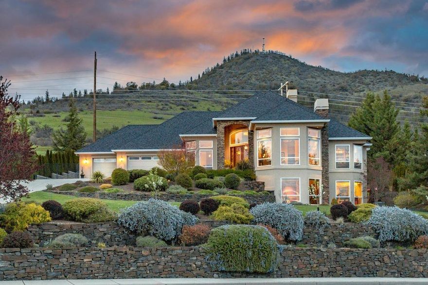 Extraordinary contemporary Mediterranean custom home. CRESTRON home automation system to operate the music, temperature control settings, window blinds, interior/exterior lighting. 20-ft ceilings. & lg windows w/views city lights, Mts, valley & sunsets. Gourmet kitchen w/ granite, stone & top of the line appliances & opens to breakfast nook, a comfy family room w/custom cabinets & amazing formal dining rm. Home features 5 fireplaces, wood, slate stone & tile floors, custom crown molding, custom wrought iron front door & 500-bottle wine cellar. 1174 sq ft heated 3-car garage w/epoxy floor & backup generator. Master Suite w/fireplace & door to private backyard. Master Bath dbl vanity, jetted soaking tub & lg tile shower & lg walk-in closet. Downstairs media room w/built-ins, state of the art sound system, wet bar, guest bdrm, workshop, workout rm & craft rm. Relax under the covered patio, exterior wood fireplace, heated Pebble Tec Pool. 50 ft RV parking w/hook-ups