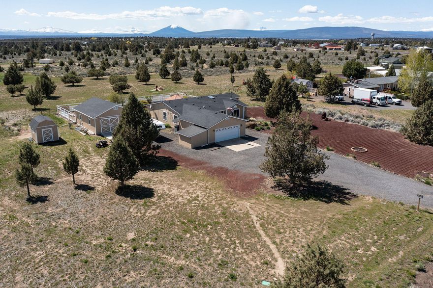 Enjoy stellar views from your dream property in the heart of Central Oregon w/nine snow covered peaks as a backdrop! 2 acres of flat, well manicured land that is great for horses, hobby farming, & a buffer from the real world! Well maintained home w/1,976sf of open living space that boasts a thoughtful layout w/large living & family rooms + bright natural lighting w/skylights, wood burning stove, & spacious kitchen w/eating bar & dining nook. Sliding glass doors boast pristine MTN views from the main living area. Well appointed primary bedroom w/walk in closet, soaking tub & shower. 2 addtnl guest bedrooms & full bath. Large laundry/mud room w/sink & built-in cabinetry. Outside you'll find the perfect patio setup w/pergola, low maintenance landscaping, plenty of space for entertaining or BBQ, & views from Mt. Jefferson all the way to Mt. Bachelor! 24x32 heated & finished shop, 10x12 shed, oversized garage w/built-in storage, RV parking too! New paint on the exteriors & new roof!