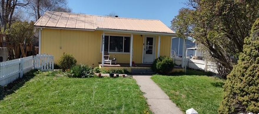 Adorable Mt Vernon Home On Large Lot!  Located on .26 of an acre in a nice neighborhood, cozy home of 1380 sq ft, kitchen features beautiful wood cabinets, laminate counter tops, dining area, 3 bedroom, 2 bath, oil monitor, cadet and woodstove heat, tile, laminate and carpet flooring, ceiling fan, utility room w/outside access, some vinyl windows, metal roof with gutters, covered front deck, partially covered back deck, sidewalk, fenced yard, partial privacy fence, fenced garden area w/raised beds, chicken coop, 18x28 shop w/concrete flooring, wired for 220, insulated cold storage room and a lean-to w/wood storage area, fruit trees, berries, mint, lavender, perennial flowers, shallow irrigation well,  on and off street parking.  $235,000    #1154