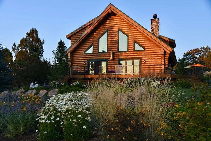 Fantastic location in the HEART of Tumalo on 2.27 acres with exquisite Cascade Mountain views! Classic log home architecture features an idyllic setting moments from Downtown Tumalo, lush gardens and light-filled spaces throughout. Great Rm offers dramatic vaulted ceilings, dining area w/access to back deck, wood burn stove and overlooks the majestic Cascades and High Desert landscape. Recently remodeled cook's kitchen w/slab granite, SS appl, vintage-style range, and walk-in pantry. Main level Primary Ste features 2 walk-in closets and fully updated BA w/tiled shower and slab vanity. Upstairs: 2 BR, darling 2nd BA w/clawfoot tub/shower and huge loft Bonus Rm. Extensive deck looking out to the Cascades is simply magical and perfect for entertaining. Oversized 3 car garage w/finished flex space ideal for home gym PLUS spacious shop area. Fully fenced property complete w/solar powered gated entrance and delightful greenhouse to enjoy. A private oasis yet only 10 minutes to Downtown Bend!