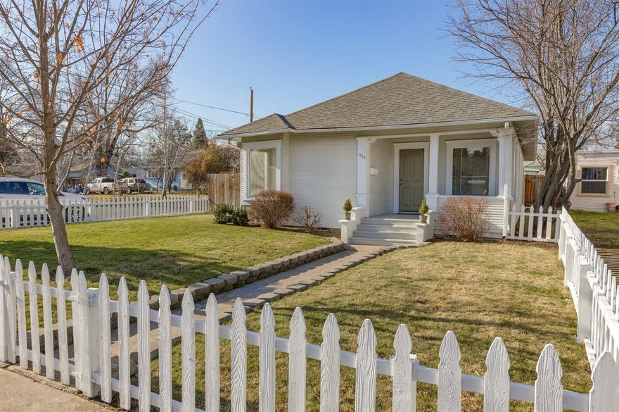 This adorable cottage is ready for it's new owner. Built in 1900 this home has been nicely updated over the years. Cute covered front porch leads you in to spacious living room with corner window seat, fir flooring, wainscoting, kitchen has nice cabinetry with character, good counter top space and walk-in pantry. Main bathroom has claw foot tub and pedestal sink; master bedroom with sitting area; detached garage with sliding track door and workshop area. Yard is fenced and nicely landscaped. This home has great curb appeal and is move-in-ready!