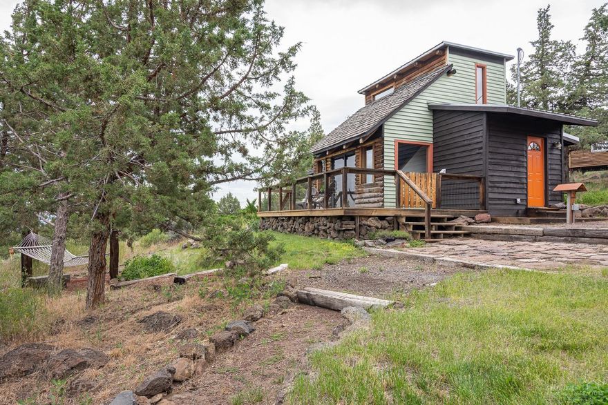 Living is easy in this private Bend Oregon cabin perched at the top of Long Butte. Enjoy Panoramic Mountain Views Of Mt Jefferson & Three Sisters, & Smith Rock. This charming cabin lives large with an abundance of large windows to enjoy gorgeous views from every room. The two story vaulted ceiling opens to an upstairs loft which could be used as a second bedroom or office space. The detached she-shed'' can be the perfect studio space, music room or guest quarters. The 1,000 sqft shop is heated for comfortable year round use. It is also metered separately with 240V circuits, making it ideal for business. Don't miss the upstairs loft space that offers even more storage or sleeping quarters. Property backs to over 80 acres of county land featuring ancient juniper groves.