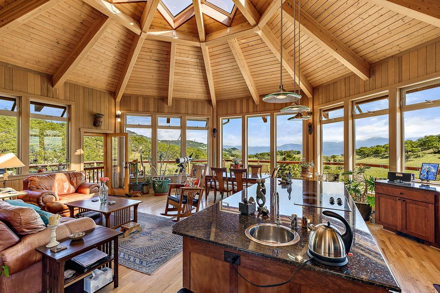 Imagining a place with peace and serenity in abundance led the current owners to this magical Ashland property. They built this exquisite 3 bedroom, 2 ½ bath residence on an open, private and expansive 95 acre property. The home itself is a work of art, boasting an octagonal design that effortlessly blends with the natural landscape. Immerse yourself in breathtaking vista views from virtually every window. Inside, built-in Cherry bookcases add a touch of sophistication and convenience. Prepare to be inspired by the extraordinary great room adorned with expansive windows and large skylights, seamlessly merging the indoors with the out. Natural light floods the space, creating an ambiance that is both uplifting and serene. The strong well and holding tank ensure reliable water to the house and garden.  Embrace the short drive and experience the wonders of this idyllic home, for the reward is a abundant and harmonious blend of comfort, elegance, and unspoiled beauty.