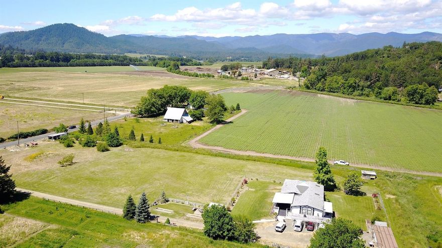 Back on market!!! Irrigation! Majestic fields and farms surround you just minutes outside Grants Pass with this nice home with extras. All irrigated with Well and or Irrigation from Canal. The house is completed gated all the way around and you have plenty of carport parking and storage. Large Vaulted Living room with family room off the kitchen. Master Suite on one side of the house and two beds and one bath on the other. There is a Caretakers quarters next door that is negotiable with sale of home that is a nearly 40' Trailer with slide outs. 2 bed/1 bath with Living and Family room and all hookups. There is a covered patio in the front and in the back. The possibilities are endless with the flat pasture land and has sprinklers throughout. Fishing and dock just down the street on the Rogue River. This one is a gem in the Ft Vannoy area of Grants Pass. All information deemed accurate but not guaranteed and subject to change at any time.