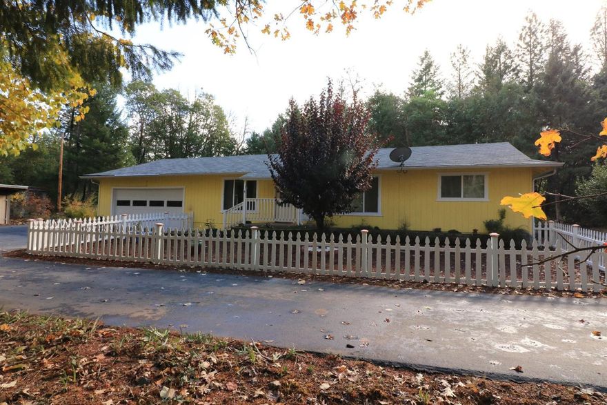 Everything on your list! Fenced 2.56 level acres, updated home, attached garage, pool, 16 x 24 shop with 12' ceiling and 8' door, 2nd garage size building with bathroom, established garden, fenced pasture, garden shed, paved circle driveway, RV Parking, tree fort, woodshed and more! Privately set, the property is gated and fenced, and there is a picture perfect white picket fence and covered front porch in front of your home. Living room features a certified woodstove for that extra warm touch, Dining area and bright open Kitchen with granite counter tops, eating bar, stainless appliances, nice oak cabinetry, laundry and glass doors to the fenced patio, pool and hot tub! The home has a Master Suite with walk in closet and bathroom with shower, two additional bedrooms and main bathroom with shower and jetted tub. Totally renovated in 2008, there is a heat pump for heating and cooling, composition roof, double pane windows, insulation, immaculate and move in ready!