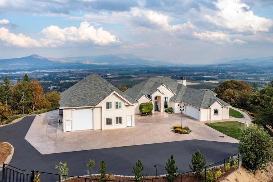 Magnificent, contemporary estate w/unsurpassed views of the valley, city lights & Mt. McLoughlin. Located w/in the exclusive Suncrest Estates community on over 20+ peaceful acres w/a private gated entry. Just minutes to Historic Jacksonville & downtown Medford, enjoy single level living in this 3 bed, 2 bath home. Soaring ceilings, hardwood floors, designer lighting, floor to ceiling windows, plus a spacious & open split bedroom floorplan, ideal for hosting & entertaining. This property lies at the top of the hill on very flat, usable grounds w/handicap access & No Stairs! Large, open chef's kitchen w/granite countertops, ss appliances, abundant prep space, & custom cabinetry. Luxurious master retreat w/a spa-like ensuite, spacious walk-in closet w/built-ins, & a sitting area w/a wall of windows to bring the outdoors IN! Fantastic 2 story, 3,000 sq ft shop w/additional finished living space, 2 car garage, & HUGE finished RV garage. Truly a spectacular home on a very special property!