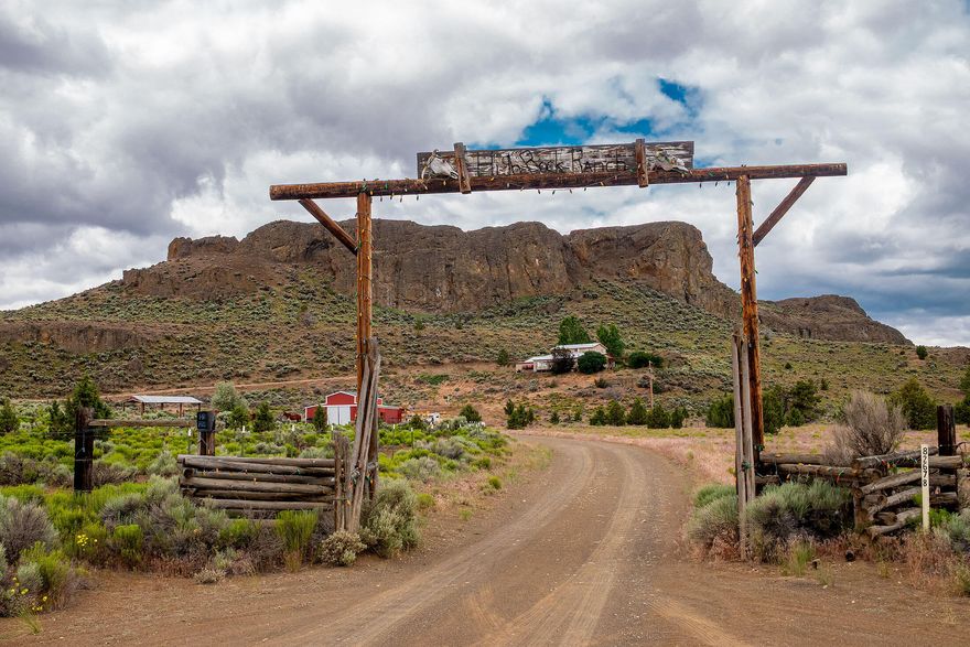 Rooted in country,  40 private acres with sweeping valley views, this property offers the space, quiet, and charm of small-town living. The 3,462 sq ft home features 4 bedrooms and 3 baths, including two spacious primary suites—perfect for multi-generational living or hosting guests. The updated kitchen shines with hickory cabinets, a huge island, new countertops and backsplash, coffee/buffet bar, wine/mini fridge, and two dishwashers. New laminate flooring, a cozy woodstove, mini-split (2024), and whole-house water filtration add comfort. Pet-friendly features include an automatic dog door, food/water station, and invisible fence. Outside, you'll find a 1,872 sq ft barn, horse shelter, power, and automatic livestock waterers—fully fenced and ready for animals. Whether you're dreaming of a working farm, peaceful retreat, or space to roam, this one checks all the boxes.