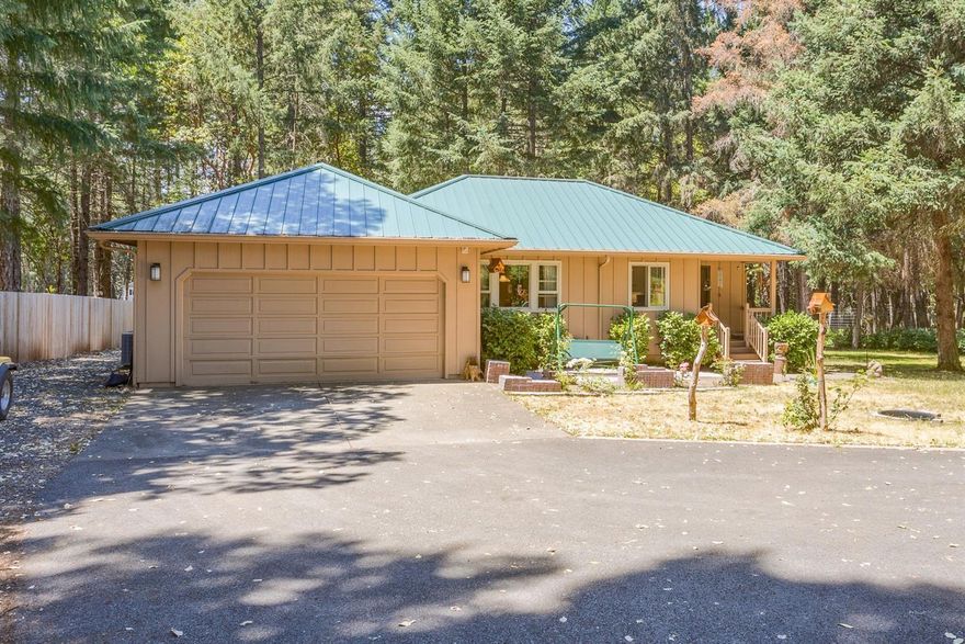 Beautiful wooded setting for this sweet cottage on 1 fenced acre. Home features 2 bedrooms, 2 baths with 1159 sf. and built in 1992. Living room with vaulted ceiling, plant shelves and ceiling fan. Kitchen has granite counters, stainless steel appliances, under counter lighting and pantry. Master with cultured marble shower, 2 closets, vaulted ceiling, bath with heated floor. An attached 2 car garage; RV parking and paved driveway. A welcoming covered front porch and rear deck. Mature landscaping and sprinklers. Close to the famous Rogue River and Griffin County Park. Don't miss the virtual tour.