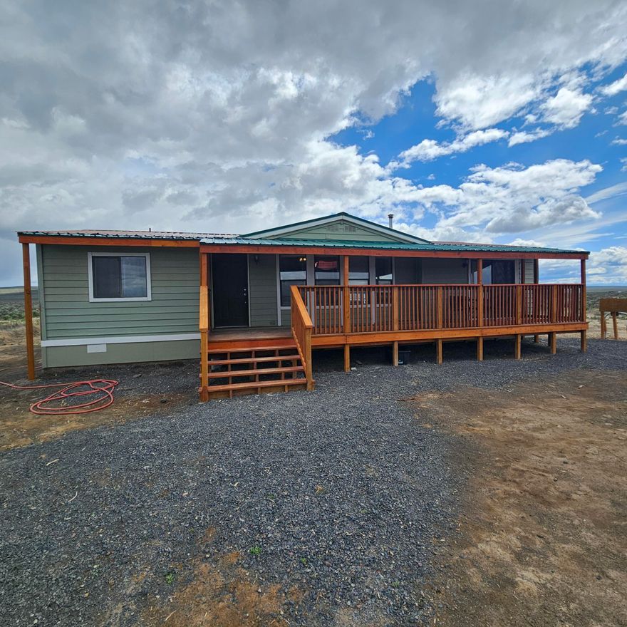 Enjoy dark sky nights and amazing sunrises east of St. Patricks Butte on this natural 20 acre parcel. The manufacture home has been moved 1x but is fully permitted and offers boundless opportunity for those seeking an open floor plan with 3 spacious bedrooms and 2 full baths. The attached green house offers 3- season growing and a good starting place protected from the elements and range life. There is plenty of room to build a shop or garage, and the storage shed/well house offers short term solution Previous tion to storing of tools.  Buyer lost their funding due to sale fail on their end. Home has been inspected and repairs of note addressed. This is one to see!