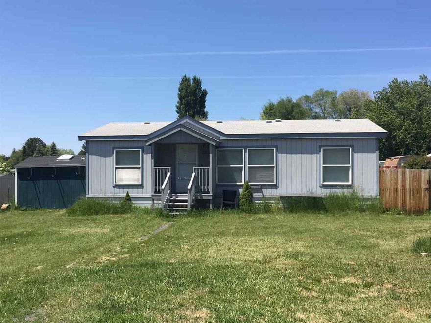 Double Wide Manufactured Home On .43 Acre. Out Buildings Include; Shop Building With Overhead Storage, Utility Shed And Garden Shed. Enterprise Irrigation Rights. Walking Distance To Grocery Store And Businesses. Split Floor Plan With A Private Master Suite, Large Bathroom And Walk In Closet. Clean And Move-in Ready!