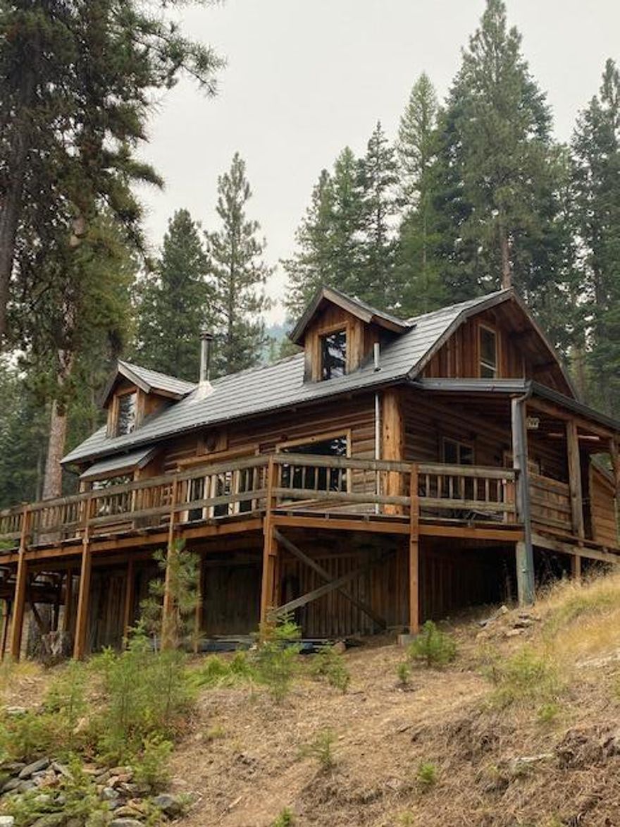 Great Off Grid Recreational Get Away On 10 Timbered Acres!
Private setting, year round creek, limited winter access, mt views,  log cabin w/lofts, open floor plan, vaulted ceiling, kitchen w/breakfast bar, dining area & window seat, 1056 sq ft, built in 1979, 2 bedroom areas, 1 bath, natural hardwood flooring, propane & wood heat, beautiful rock accents, wrap around deck, metal roof, generator, well, septic, storage for generator, covered firewood storage.  $310,000