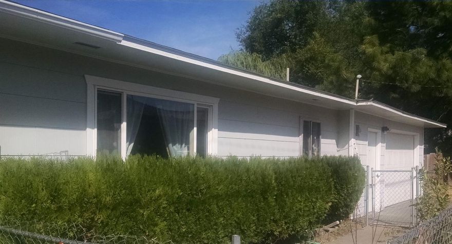 Cute 2 bedroom with newer paint and flooring. Cadet heaters in bedrooms & bath. Oversized one car garage with 2 separate storage rooms. Laundry is in the attached garage. Fenced yard. New roof in 2005. Located across from Fred Meyer.