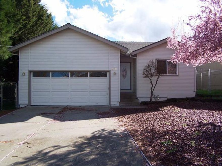 Affordable Ashland living with a close to downtown location.Semi-private on a non-thru street. 3 bedroom, 2 bath single story situated near the end of East Nevada where it stops at Bear Creek (not in any flood zone).Home has no carpeting throughout for those allergy or air quality conscious, having bamboo flooring in all bedrooms and the great room seating and dining areas, with ceramic tile in the entry, kitchen, laundry, and both bedrooms. Large Master with a spacious walk-in closet and private bathroom with two sinks and lots of cabinetry. There is also a nice elevated deck off of the great room. Two car garage completes the picture. Come and enjoy all Ashland has to offer!