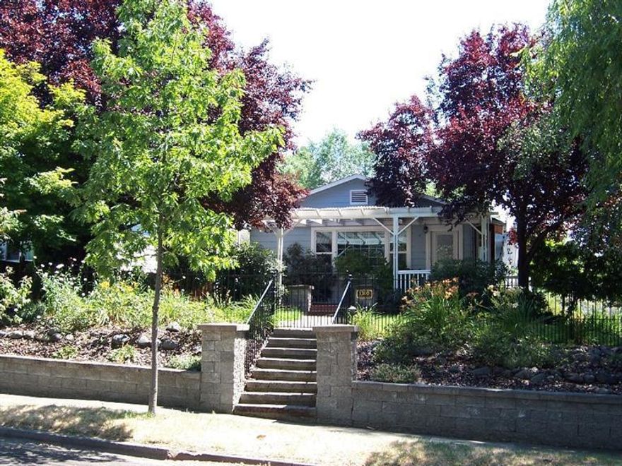 Large comfortable home in a great old East Medford neighborhood. Gorgeous mature landscaping. This 3 bedroom, 2 bath, 1948 built home has approx. 2039 sqft. and has been updated over the years. This home features a large living room with fireplace, built-in bookcases and bay window seat; formal dining room; nice open kitchen with pull-out pantry and breakfast nook and laundry room. Daylight basement area has a private guest bedroom and bath, and a great shop area. Enjoy the spacious covered front porch, plus a covered patio and additional separated covered side porch.