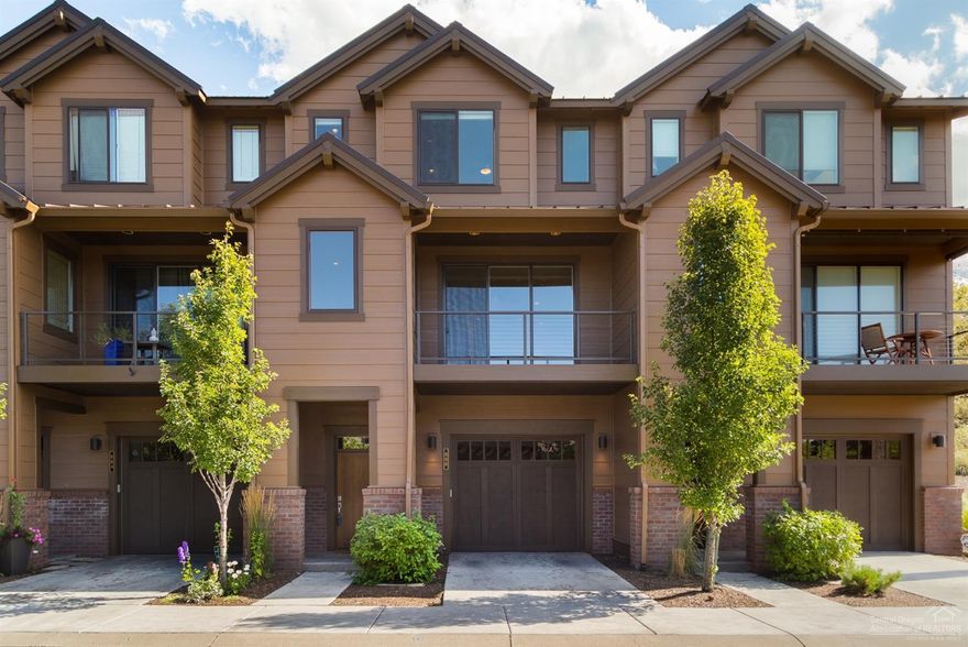 Luxurious townhome with spectacular River & Mountain views, Located in the exclusive Deschutes Landing Neighborhood in the heart of the Old Mill. This home is just steps away from the Deschutes River, restaurants and shops. It features and open floor with plenty of room for entertaining with a large deck area off the living room as well as a nice office nook and A/C. The kitchen area boasts high end appliances and custom finishes throughout. The large master suite features walk-in closet, upgraded master bathroom with high end tiled glass walk-in shower and custom lighting. Over-sized 2 car tandem garage with shop area plus lots of room for storage, toys, etc. Private fenced patio/backyard. Brand new exterior paint. Short term vacation rentals are allowed.