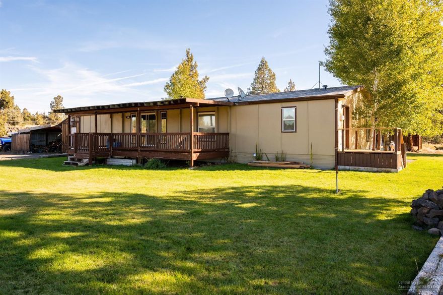 4.5 acres of High Desert sage, juniper and lava flows await your creativity in Redmond's Tetherow Crossing. This financeable 1609 sq ft 3 bed, 2 bath manufactured home has a large kitchen & living space with separation between the master and the other 2 BR's. Find serenity from peek-a-boo views of North and Middle Sister from the front and Gray Butte from the back. Partially fenced for horses or livestock, this home also has sprinklers greening up the front and back to go with over 3 acres of natural land. The custom chicken coop, round pen and a horseshoe pit are sure to keep you busy with hobbies new or old. There is a tool shed and covered work area large enough to park under. Keep cozy this winter with a certified wood stove or your furnace powered by CEC. Home is on a shared well & standard septic system & has plenty of room for a shop. Just 10 minutes from downtown & on a paved road in, this neighborhood is bordered by BLM on three sides & the Deschutes River to the south.