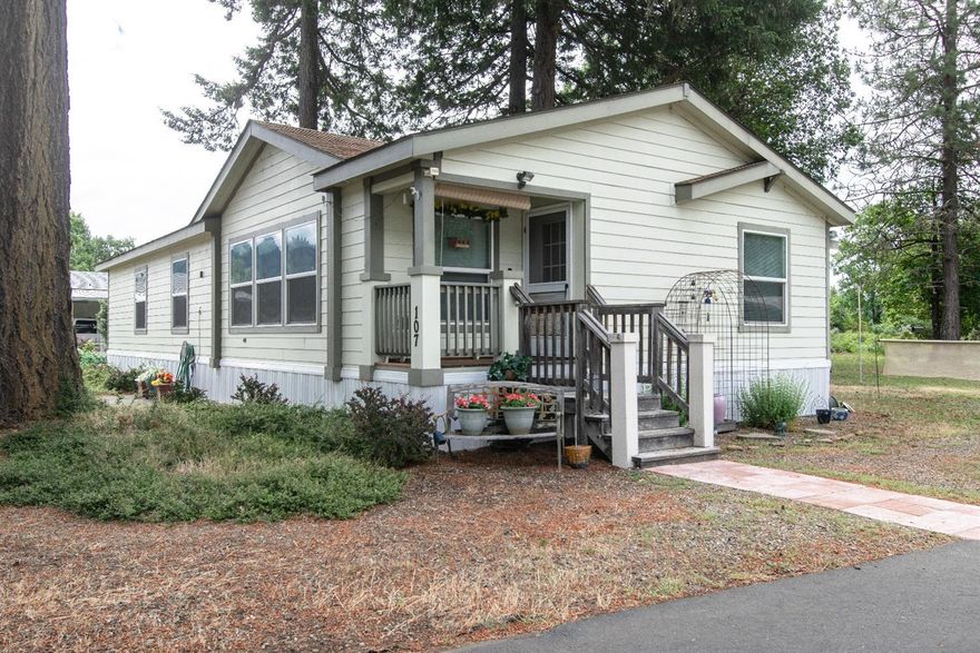 This beautiful home was a show room model and it shows throughout. Sitting amongst the tall pines at the end of the quiet River Valley MH Park, where you feel like you are in the middle of the country. The well designed, open floor plan has plenty of over-sized windows to let the country feeling in. A real propane fireplace to warm your evenings. The walls have shelves for plants and your special items as the floor plan flows into the large kitchen with a pantry. All kitchen appliances stay. Large W/D room with oversized laundry sink. Carport is anchored. 180sf back deck overlooks the private backyard and woodland area where you will see plenty of wildlife. This comfortable showroom model is ready for you to call it home.