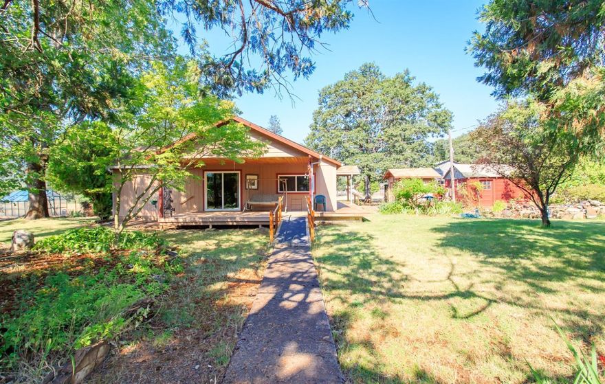 If you are seeking a quiet location, with land... Pick up the phone! Fantastic well at 25GPM, 2 fenced acres of level ground, 1824 square foot home, plus a shop building & paved driveway, all located on a dead end street. Large trees, mature landscaping with pretty plantings, nice water fall and pond with lilies in bloom, set the stage for this well built home with heat pump, large kitchen & dining area, living room with fireplace, nice master bedroom with pretty bathroom. Large rooms throughout, double pained windows, and trex decking. Minutes to Shady Cove and 20 miles from the Medford Airport.