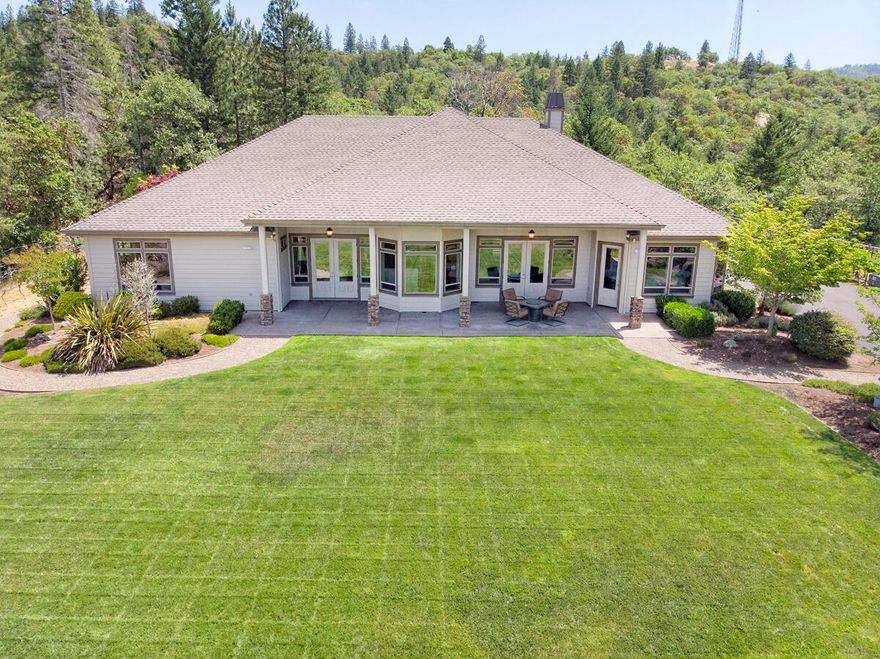 This 4315sf retreat/residence sits on 5 private acres with gorgeous mountain views. It's grand 8' entry doors invite you into exquisite living spaces of vaulted ceilings, a stacked stone fireplace & scraped hardwood floors. The entryway leads you to the anchor of the home where the well appointed kitchen with granite counters, center island, wine cooler, gas cooktop with double convection wall oven and stainless appliances awaits. You can't avoid being captured by the floor to ceiling windows in the surrounding living/family rooms offering up a canvas that stretches to the sky.  With 4 bedrooms and an addt'l room as den or office, the master suite is elegant with built-in cabinetry, gas fireplace, large bath area w/custom stone & tile shower. Upstairs spacious loft.  Finished 3 car garage, with epoxy layered floors, 220V power, 400 amps & RV parking. The property is fully fenced with a security system network and just a short drive to all amenities. Too much to list, much more to see!