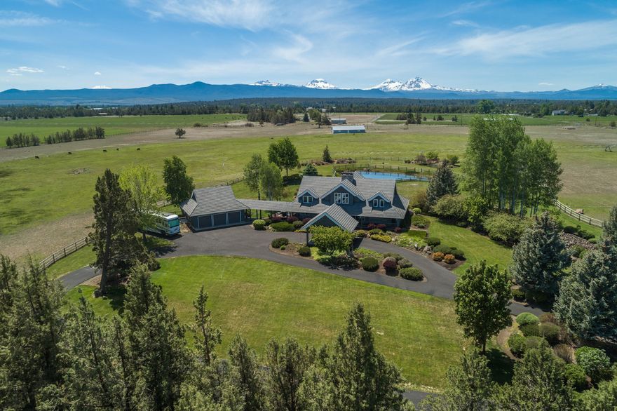 Stunning 9 Cascade Mountain Peak Views are enjoyed throughout this custom log home. 4 bedroom/4 full bathrooms on 39.17 acres in Tumalo, Oregon! Floor to Ceiling windows in the great room allow for the incredible views to stun you each and every day. The grey washed logs give this home a warm, modern feel. Large stacked stone fireplaces set the tone for making memories in this incredible home. Entertain on the large wrap around deck overlooking the pond and the breathtaking mountain views will sure to delight. Formal Dining Room. Triple Car Garage and Large Shop/Equipment Barn with plenty of room for storing all your toys and gear. Easy in and out with circular drive which includes new heavy duty asphalt section to accommodate heavy loads. Fully fenced with a gated entry. 18 Acres of Irrigation set up with a newer pivot. RV Parking. Private Well. Farm Deferral. This property is a rarity to hit the market.