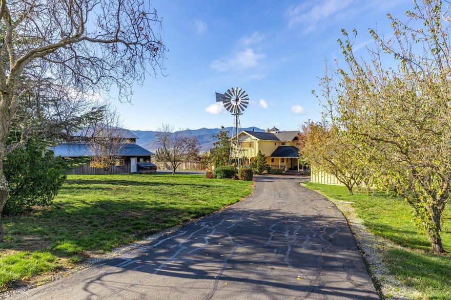 Welcome to a beautiful French country farm home located in the east foothills of Southern Oregon. Care, quality and consideration is evident as you move through the home, from the lovely window seat in the kitchen to the inviting family room.  For the extended needs of today a great office and what a wonderful master bedroom suite. Expansive views that go down across the valley to the mountain ranges, and great outdoor living with your inground pool, outdoor shower and sauna.  Fabulous barn with an exercise room, shop area and cozy upstairs for an art room, office, guest space or whatever you may need. 34.4 acres, and 31.6 acres are irrigated, featuring a pear orchard, with a gravity system and underground main lines for ease! Annual lease available – or – this property would be prime for conversion to another ag use such as a vineyard with excellent western and southern exposure! What a wonderful opportunity here in the Rogue Valley!