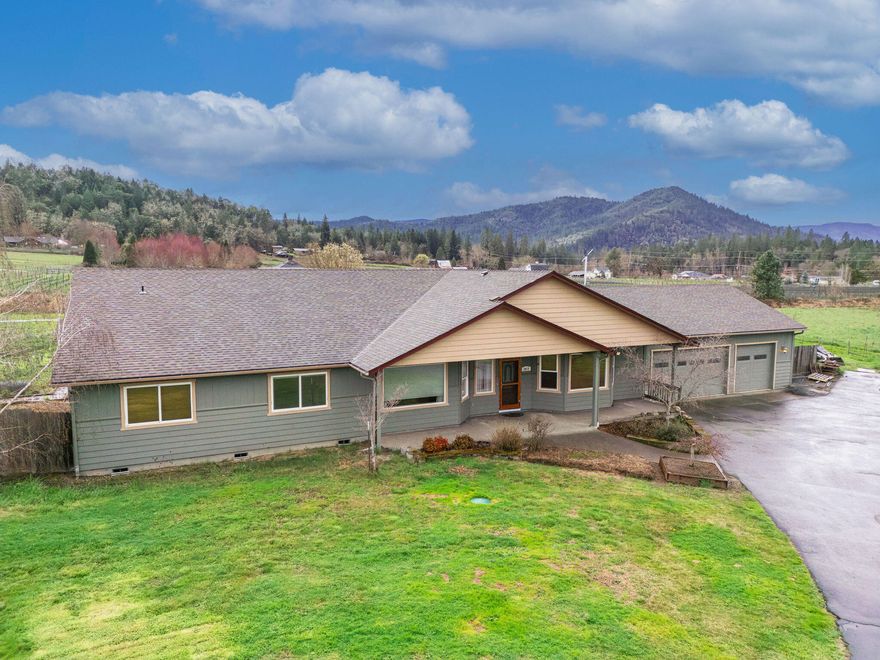 This Southern Oregon beauty features gorgeous views & sunsets you will have to experience! The home has been well maintained over the years & provides 2947 sq. ft., 3 bdrm, 2.5 baths with an additional room perfect for a home office or 4th bdrm. The fabulous spacious kitchen is a chef's dream & boasts a large island, double oven, granite tile countertops, walk-in pantry & an abundance of cabinets & counter space. The great room has vaulted ceilings & a spacious dining area with French doors to the patio area where you, your friends and family can enjoy the in-ground pool & a pond. Off the kitchen there is a laundry room with half bath. The primary bedroom is elegant with its plush carpet, walk-in closet, & in the primary bath you will enjoy a step-in shower & a jetted tub. This home has an attached 3 car garage with plenty of storage located above the garage. Outside you have RV parking with electric & water hook-ups. So much to offer including fruit trees & irrigation rights.