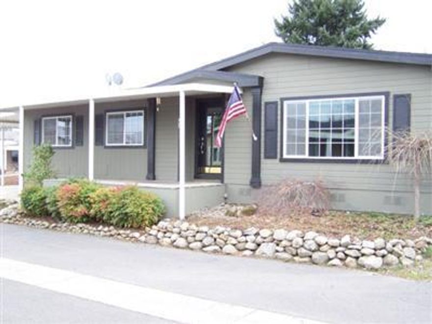Located in Whispering Pines Manufactured Home Park! Vacant & ready for immediate occupancy. This 1998 built triplewide home is 2016 sf., large floor plan, quiet area, large back deck with hot tub, pond and nicely landscaped. Reliable community water system. Very clean park. Home is on a cul-de-sac at west side of park. Must See!