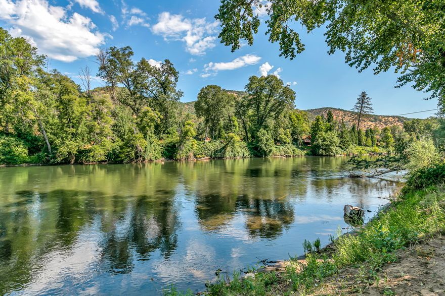 Picture yourself waking up to the tranquil beauty of the rogue river, where every moment feels like a dream! The surrounding mountains, trees, and river are breathtaking!! This home features a great floorplan which showcases a large primary bedroom w/ two separate beautifully renovated bathrooms, two additional bedrooms featuring a jack & jill set-up, and a lovely galley kitchen. A decorative stone wall with wood burning stove insert makes the living area cozy and inviting. The outdoor upper level has a flowering garden area and patio, while the lower level to the river offers the perfect canvas to create your own beachfront oasis! This home has been thoughtfully updated with many amenities including a beautiful front yard, fencing, privacy gate and new RV pad giving this home charming curb appeal! There is an extra 400 sqft bonus room that's not included in the recorded square footage.