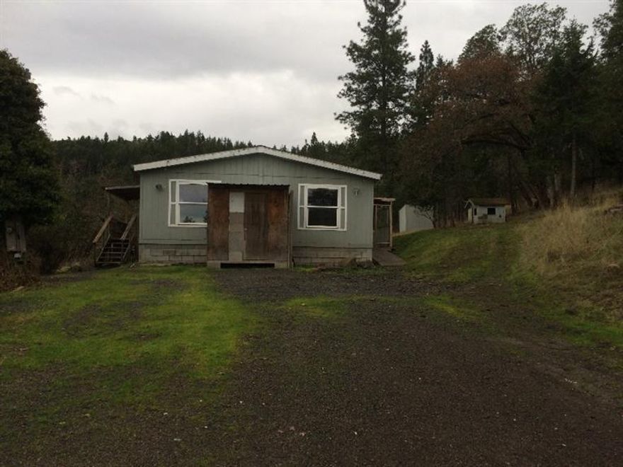 Enjoy these AMAZING views in your very own wilderness. Manufactured Home is peaceful and serene. Needs some TLC but would also make a great homesite.
