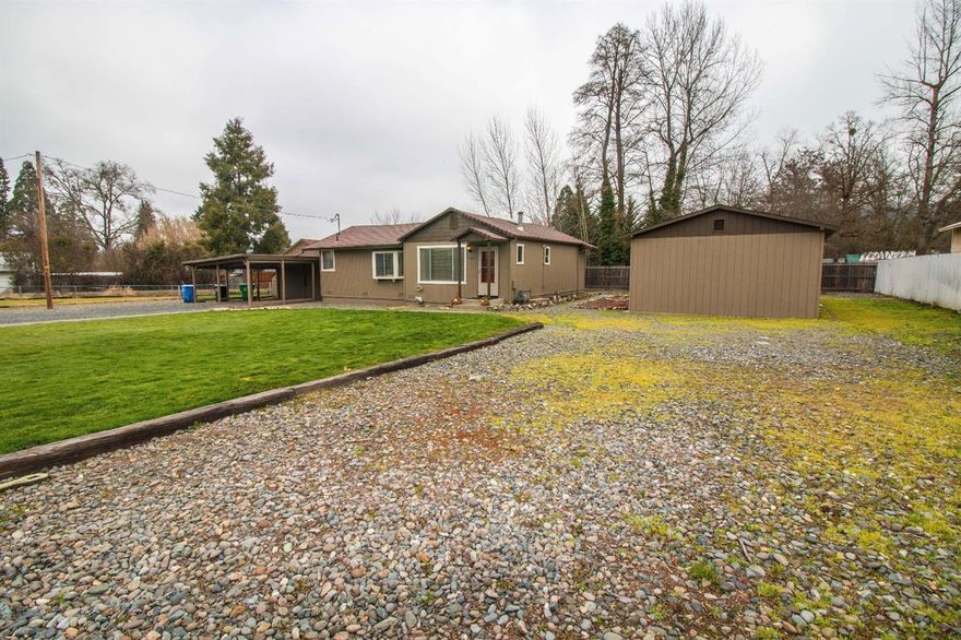 Charming updated home on over half acre and fully fenced. Just minutes from town, hospital, parks and schools. Great open floor plan for entertaining. Nice updated carpet, tile and laminate flooring throughout with cozy gas fireplace. Enjoy the private deck off of the master bedroom with hot tub possibilities. Detached 2 car carport with attached shop with an additional 34 x 17 shop. Bonus RV parking and room for a garden. Priced to sell!