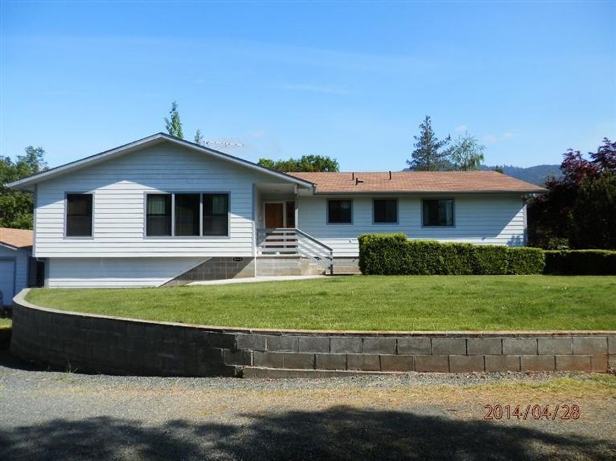 Close in yet private. Very well built home with 3 bedrooms and 2 full bathrooms. Lots of trees, shrubs and garden space. Fully fenced with separate dog run. Auto gate at entry. Large three bay shop with 12 foot doors and half bath. Separate two car garage next to the home. Three good sized bedrooms, separate family room and living room. laundry room and additional storage room on ground level below kitchen. All appliances will remain with the home. Range/oven, dishwasher, refrigerator, washer & dryer. Natural gas heat. Fenced with secruity gate.