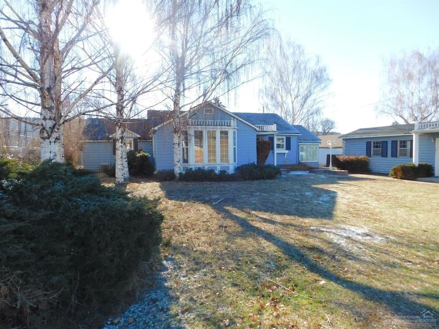 This is truly a unique property that is priced to sell. Use your ideas and expertise to restore this mid century home is it's original charm. 1 fenced acre with 1/2 acre of irrigation. 1986 sq ft 3+ bedroom 2 bath home with some original built-ins in the master and has a basement. 725 sqft rental/guest house. Newer shop with 560 sqft. Building alongside the house is perfect for a home occupation with 3rd St frontage.