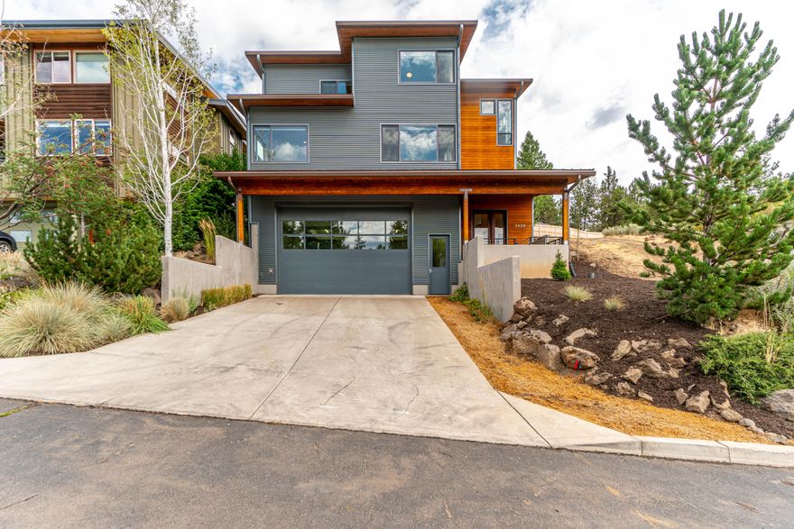 Nestled in on a dead-end street, 4 blocks from Newport Market in the heart of Bend, close to the river, downtown & westside amenities. This stunning home features a 30X26' oversized two-car garage with a 12ft tall garage door, perfect for your Sprinter, camper, RV & toys. This Christian Gladu-designed high-efficiency passive solar home offers abundant windows & natural light, an open floor plan, & hickory hardwood floors with 4 bedrooms & 3.5 baths. Pilot Butte & panoramic southern views from the great room with a cozy wood stove. The kitchen features stainless steel countertops, cherry cabinets, a butcher block island, tile floors, & tile backsplash. The main floor also has a full bathroom & bedroom, off the great room. Upstairs, the primary bedroom has 2 walk-in closets, a large bathroom with a tile walk-in shower, & views of the newly landscaped backyard. Two additional bedrooms, a bathroom, & flex space complete the upstairs. The backyard welcomes you with a deck for entertaining.