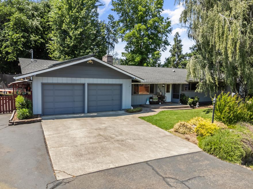 Charming country home on .42 acres in a small, low traffic neighborhood, just minutes from town! This 3-bed home has tons of character and a second living room that could easily be utilized as a 4th bedroom. The primary features 3 closets and attached bath. The laundry room with utility sink and extra storage leads to a large 2-car garage and bonus workshop area. Lots of additional parking, including an RV pad with water, power, and sewer. There are two wells on the property, one for irrigation. Plenty of room out back with a large, covered patio, mature landscaping, plenty of shade and no immediate neighbor. Two outbuildings offer extra storage or workspace. Schedule your private tour today!