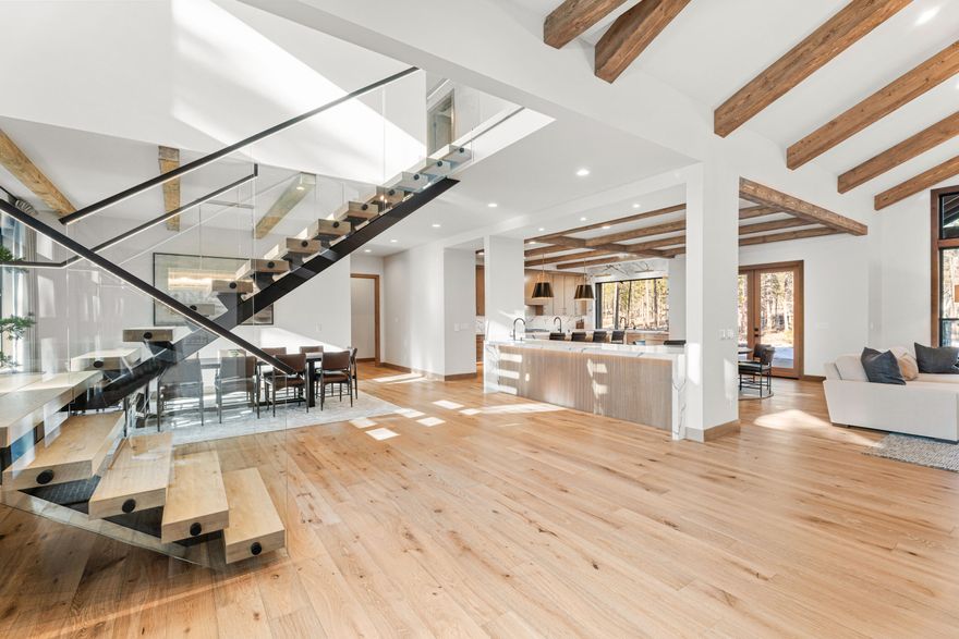 Experience lake views from this newly completed custom mountain-modern home in Caldera Springs! Designed for memorable gatherings, it features four ensuite bedrooms on the main level, a spacious great room, a gourmet kitchen with a butler's pantry, and a convenient laundry room. Upstairs, discover two additional ensuite bedrooms, bunk room and a versatile bonus room. Relax on the expansive covered patio, complete with a hot tub enclosure. Features include distress wood beams, custom cabinetry, rich woods, solid surfaces, high end appliances, and Central Vacuum with an in-wall hose, built in fridge and wi-fi enabled zoned Central A/C. Schedule a showing with your real estate professional to experience this home today!