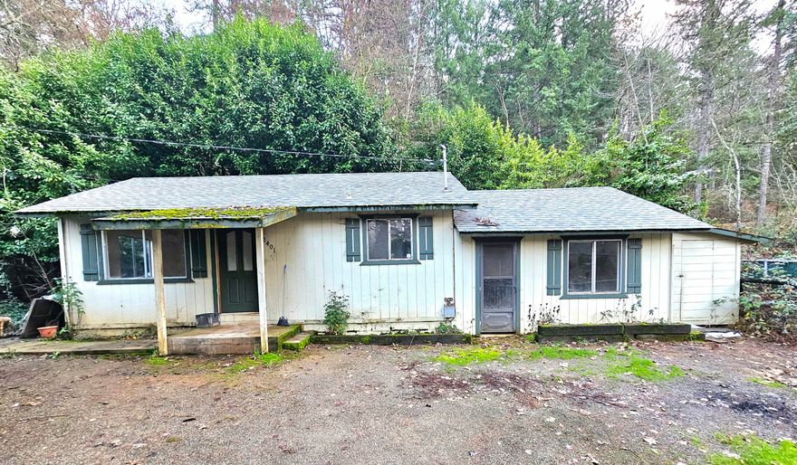 Wonderful fixer-upper overflowing with potential and perfect for a savvy investor. Several updates have already been completed. Septic tank access was updated in 2019. The roof was replaced and ductless heating and air was installed in 2021.  Plumbing and ventilation in place for a gas fireplace. Located just outside of town and minutes from schools, parks and the Rogue River. Yard is partially fenced and gated. The mature landscaping creates plenty of privacy. Nice-sized shed allows for extra storage. Home is being sold as is.