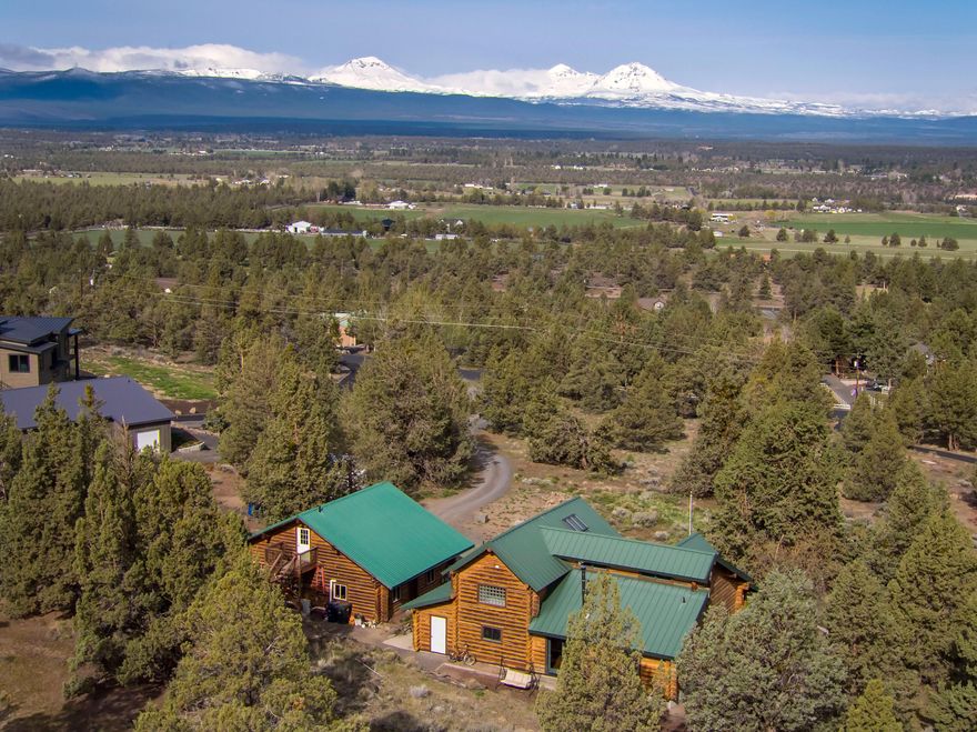 Beautiful custom log home on 2.9 acre in Tumalo w/7 Peak View of the Cascade Mountains. The country kitchen has beautiful granite countertops & sink, stainless steel appliances & alder cabinets. Areas of drywall, skylights and large wood-aluminum clad windows creates a lot of natural light in this home. A great layout with two bedrooms on the main level and separation of primary and additional bedroom on the second level. Huge covered front porch to take in the gorgeous sunsets. This home has many other special features. Garage was converted to Bonus Space with storage above.