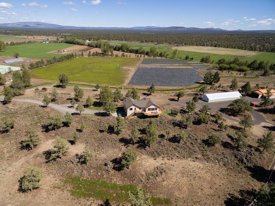 With 360 degree views including the Cascade Mountain Range from Bachelor to Jefferson, and even Hood on a clear day, this custom built 2,458 sf home on 40.18 fenced acres close to Bend is a stunning and tranquil place to call home. There is so much to this property, it is truly a must see. There is a 992 sf guest home with a separate private gated entrance, two 100' greenhouses, a 2220 sf barn/shop, two ponds, private BLM access, 5.5 acres of lavender on drip, 10 acres of water rights, full RV hookups and more. The main home also features a private, gated entrance, vaulted ceilings with windows to take advantage of the incredible views, large wrap around deck, custom cabinetry, tile wood floors, 4 bedrooms and 3 full baths. Fresh air, views, space, and nature at your doorstep. This is an amazing property!