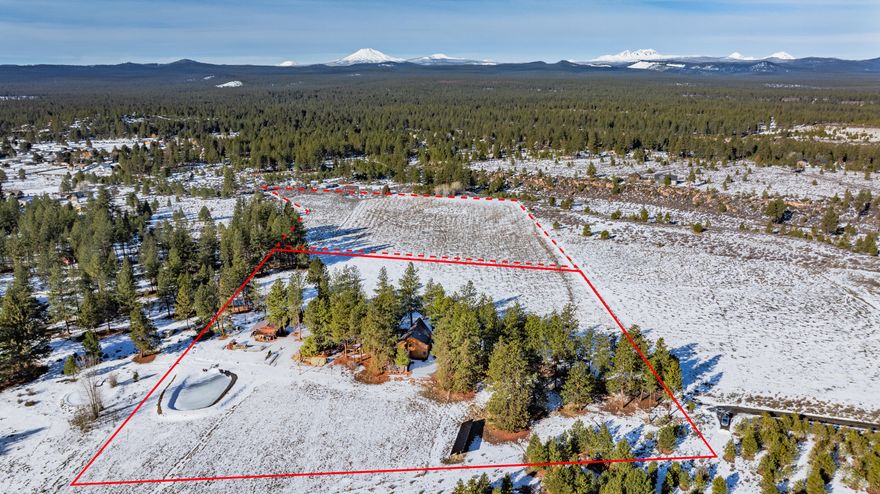 Showstopping Cascade Mountain views that will take your breath away in a prime, SW location just outside Bend's UGB. Solid cedar and timber frame construction built to last a lifetime. Onsite storage in the 24 x 68 shop plus a 6 stall 36 x 48 barn. Detached 768 single level building has a full bathroom, w/d hookups and kitchenette. The room over the garage has a separate entrance and could easily turn into a craft area or private office. A home base business owner's dream! Forget renting commercial kitchen space. This kitchen was specially designed with abundant counter & prep space. All top-of-the-line, newer appliances. Embrace the original vibe or update the flooring and fixtures to your liking. Your cabin in the woods awaits.