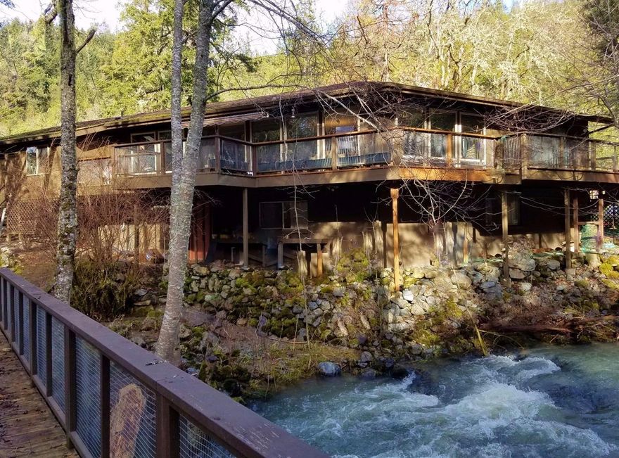 SEMI PRIVATE retreat on 3.51 wooded acres adjoining BLM, with 673 Feet of Jump Off Joe Creek Frontage. The fenced and gated property has waterfront view of the year round creek, meadows & woods from large view windows. With 1514+/- SF on the upper level & a 1362+/- SF lower level /basement this home has 2876+/- SF available living space with separate exterior access to the basement for easy conversion to a two family living unit. Nearly new Generator means no fear of power outages! Fruit trees, Sunny & open level meadow/garden areas, several patio and picnic areas for peaceful, tranquil living. An engineered foot bridge crosses the creek for easy access to the meadows beyond. Due to slight discrepancies in Prior MLS, County& Seller records, buyer is encouraged to perform due diligence regarding accurate square footage and use of property as well as flood zone.