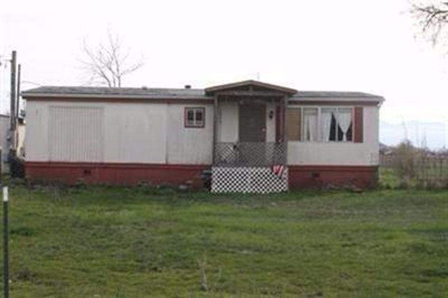 Fantastic opportunity for your investor! Both the property and location have so much to offer. Opportunity to have a 3 lot subdivision potential (buyer to do all due diligence). The lots would be large the potential is fantastic. Room for shops, swimming pools, etc. Currently there is a functional mobile home on the property. City services. Seller would consider owner carry terms.