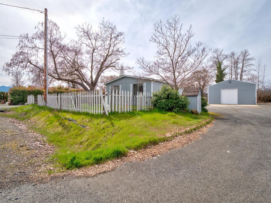 Improved throughout 2-bedroom/2-bathroom manufactured home with new roof, new interior/exterior paint, new flooring, new appliances, and new light package. Paved driveway makes for ample parking and turn around room for RV pad. Huge 1200 sqft garage with full bathroom is perfect for storage or home-based business. Must see!