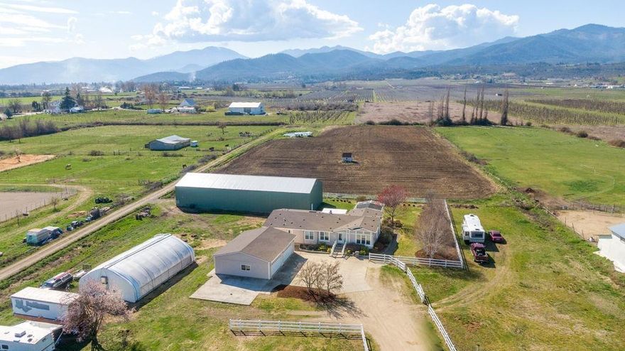 Extremely comprehensive property with diverse possibilities and an abundance of potential uses, conveniently located on the outskirts of Medford with easy access to Hwy 99 and I-5. It consists of 7.49 irrigated EFU acres; a new 40' x 110' drying warehouse/shop equipped with 2 natural gas HVAC systems, dehumidifiers and spray-in insulation; 30' x 50' automated greenhouse; 3 phase power at the street; oversize 4 car garage; Medford Irrigation with water storage pond, pump and drip; strong domestic well; public sewer and a 2,680 sf manufactured home built in 2002. Organically farmed (not certified) in 2019, the property could easily continue the hemp operation and is well suited for a boutique operation. However, with the 3 phase power and natural gas it would be an ideal candidate to expand the drying capabilities. It would also be a fantastic property for a contractor or someone needing abundant storage. Owner carry considered with $450,000 down, but not preferred.