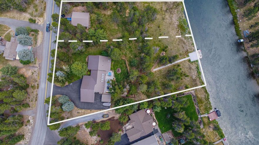 Seize this ONCE IN A LIFETIME opportunity to own 1.7 acre (2 lots) w/ 270' of riverfront on the Big Deschutes River. This meticulously maintained home features a thoughtful design w/ 7 skylights, vaulted ceilings, & 2,644 sq ft of single level living. The main level boasts 3 bdrms & 2 baths, while the 728 sq ft upstairs bonus area over the garage, includes a sleeping area, great room, & full bath—ideal for adult children, extended family, game room, or a potential rental w/ its own entrance. Step outside into your private oasis, surrounded by Ponderosa & Aspen trees.  18x50 Trex deck, a hot tub, and  fenced yard. A pathway leads to a 20x20 ft dock, perfect for fishing, boating, & serene moments on the river. 3-Car garage w/ ample parking available for multiple vehicles, boats, or an RV, complete w/ 50-amp service. Lots of storage for your gear! .53 acre lot next door included in the listing has a 1080 SF garage/shop with power. Lots of room for hobbies or extra storage! It's Paradise!