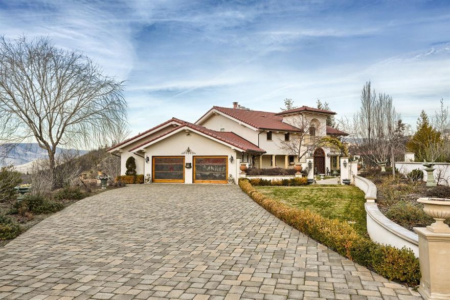 Private 80 acre country villa w/ panoramic views of the valley & Emigrant Lake. Each 4 bedroom en-suite shares this stunning view. Chef's kitchen w/ oversized island, honed granite, double ovens, prep sink, heated & refrigerated drawers & 3 dishwashers. Black Walnut floors, custom cabinetry & an 8 burner Wolf range. Upstairs is dedicated to the Master Suite; spa-like bathroom, dressing room + an adjacent sitting area w/ a wall of windows. Throughout the house is extensive use of Black Walnut, Tile & Marble, hand forged iron railings, custom 8' solid wood doors. The exterior of the windows and doors as well as the gutters are copper- for durability & style. The salt water pool is perfectly situated next to an expansive paver courtyard complete w/ outdoor kitchen, restaurant grade pizza oven & fireplace. Greenhouse, enclosed garden w/ raised beds, 1.7 acres of mature Riesling grapes. Detached studio for wine tasting. 15,000 gallons of water storage, generator back up, nut & fruit trees.