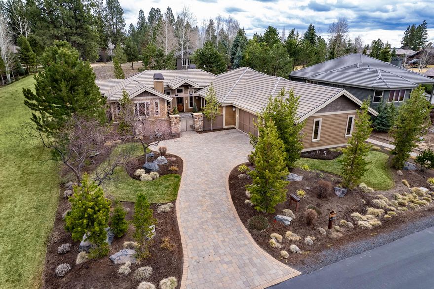 Enter into this beautiful home through a private courtyard nestled between a grassy common area on 2 sides in the desirable Broken Top community. With 3 en-suite bedrooms, an office with extensive built-ins, open great room and kitchen, this home has plenty of space. The large primary suite features one of two gas fireplaces, a sitting area, and a completely remodeled master bathroom with heated floors, a large shower, stand-alone soaking tub, and abundant walk-in closet. Drive the paver driveway into an oversized 3-car garage with epoxy coating, built-in storage, and zoned heating and AC. Built for entertaining with a chef's kitchen, a pleasant water feature off the kitchen and high ceilings. Dogs will be safe with invisible fencing. Lots of amenities in this private and secure, gated community. Secluded, yet still near your choice of shops and restaurants as well as world famous mountain biking trails, and just 20 minutes from Mt. Bachelor.